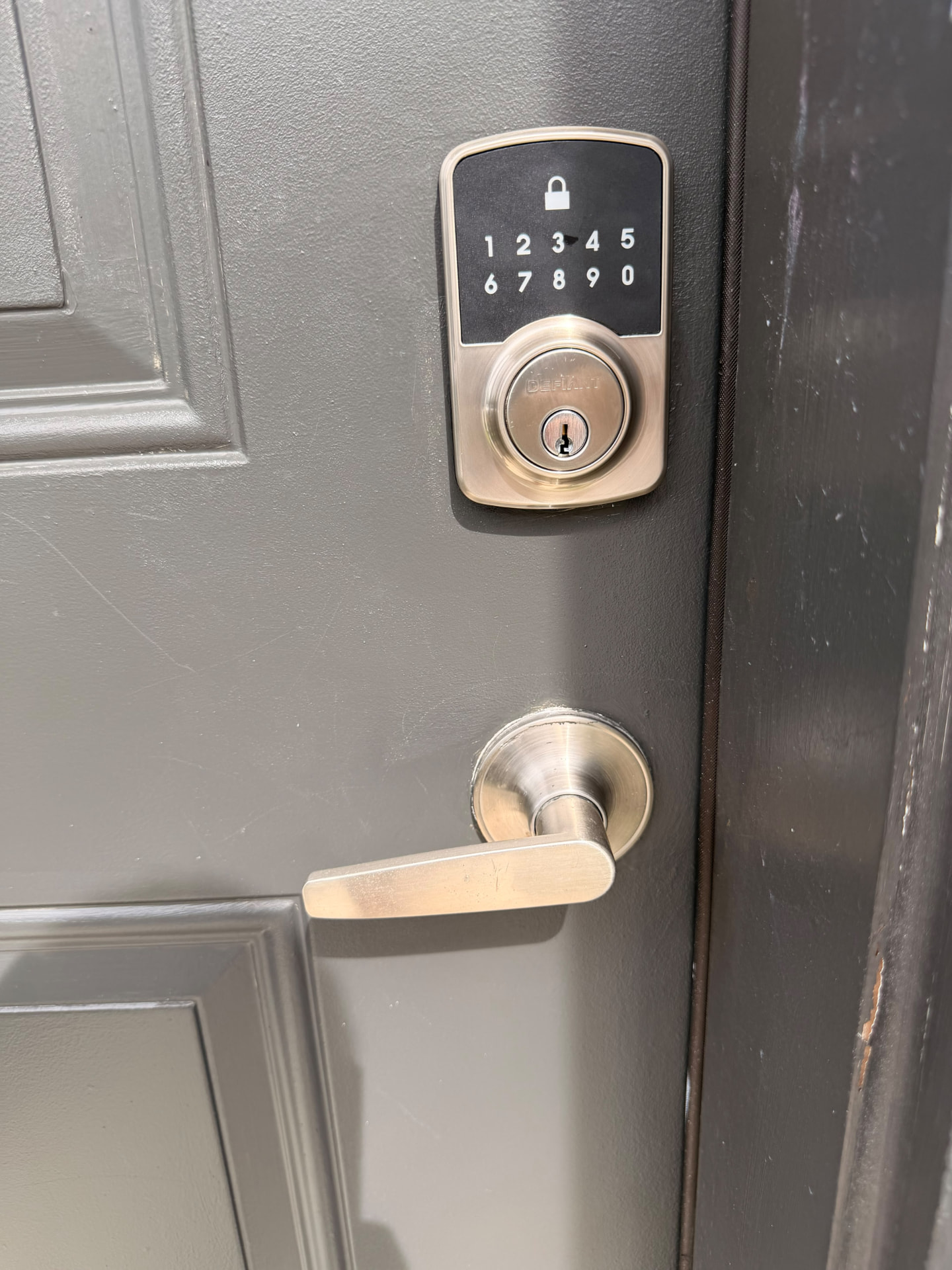 Electronic keypad deadbolt and lever handle installed on a home entry door by GO Locksmith USA