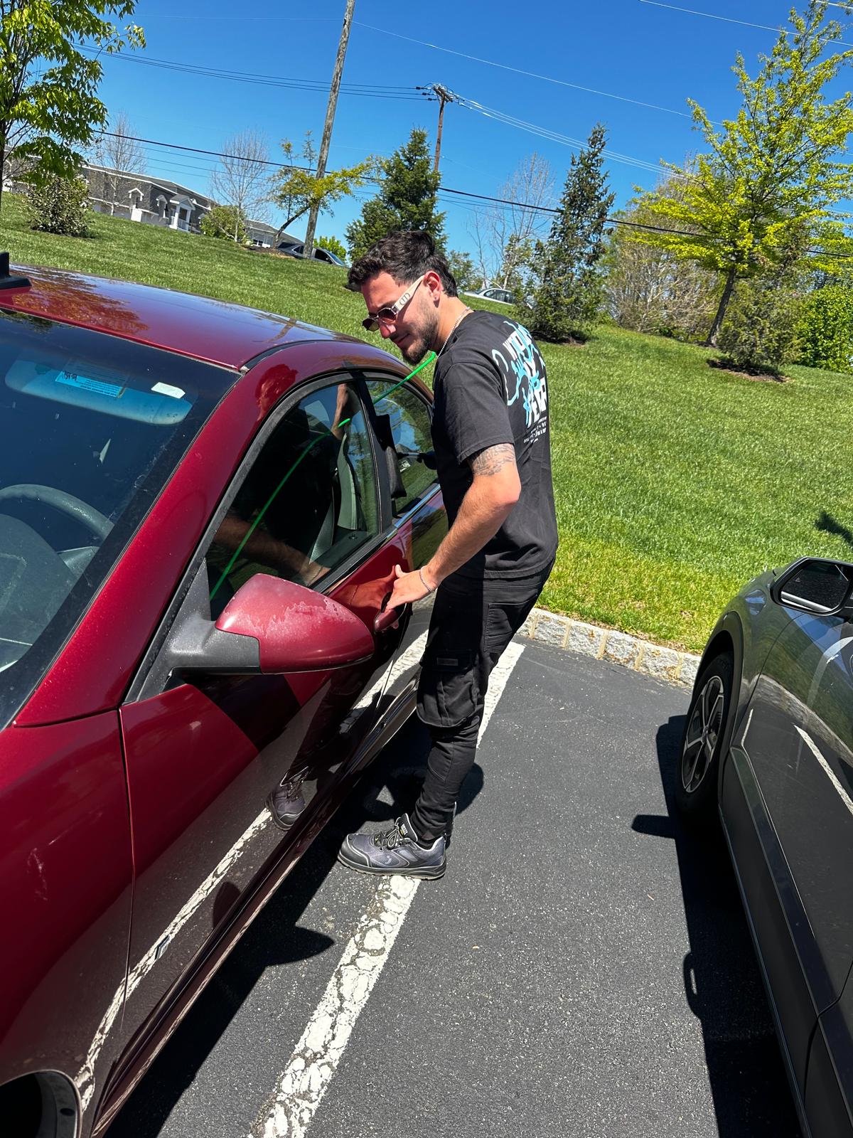 GO Locksmith technician unlocking a car door with a professional entry tool